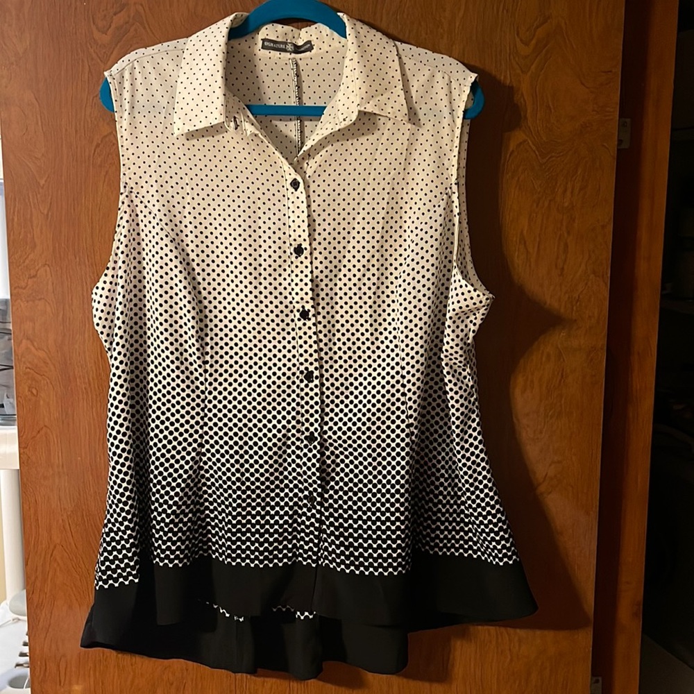Women cream top with black polka dots.